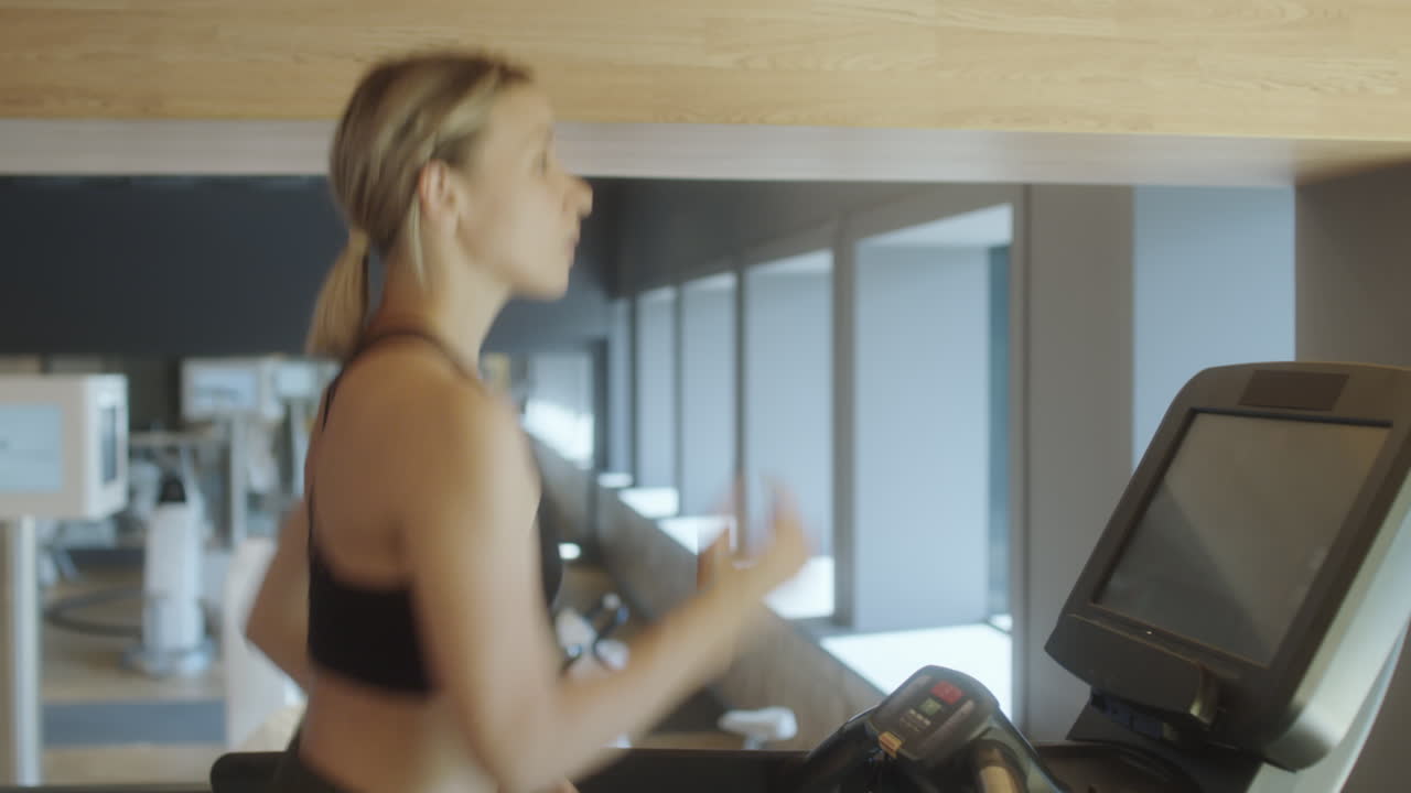 Woman Having Treadmill Workout in Gym
