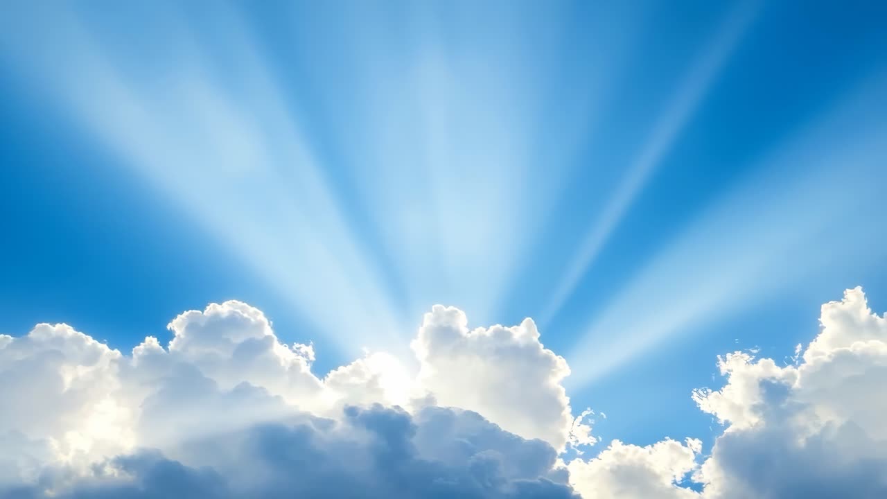 A serene video scene of sunbeams piercing through fluffy clouds, captured from a low angle