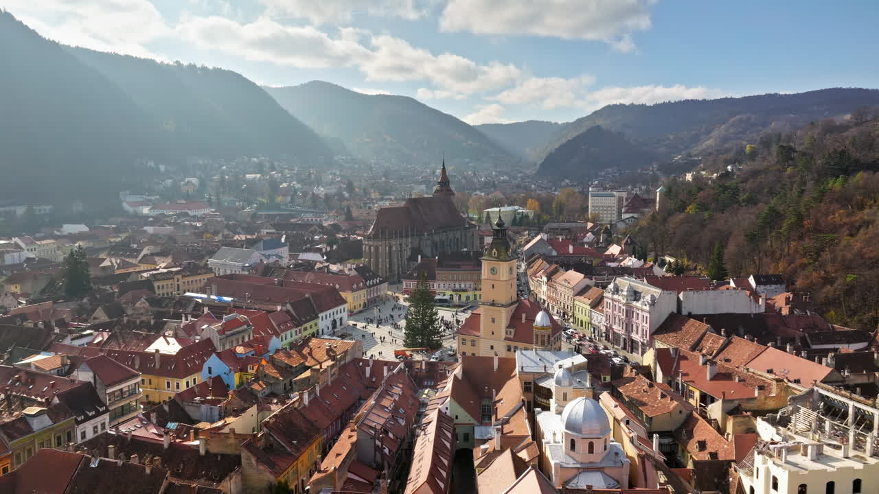 Aerial drone view of the Christmas tree being installed in The Council Square in the historic center of Brasov, Romania