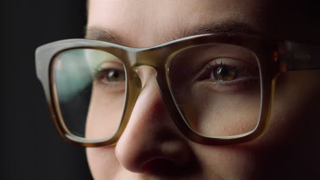 portrait of young businesswoman smiling on black background.girl wearing glasses