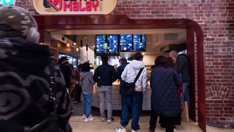 people queue at a food shop