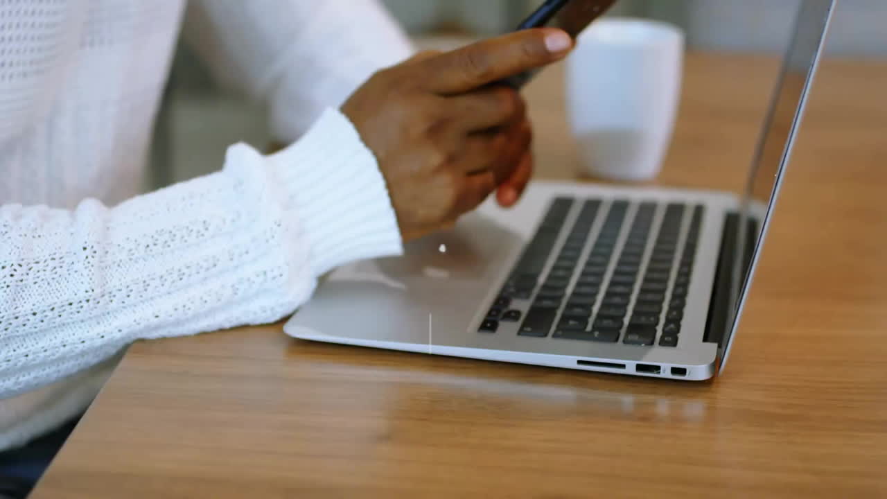 Animation of network of connections with icons over biracial businessman using smartphone