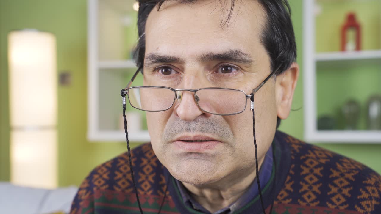 un hombre emocional llorando solo en casa.