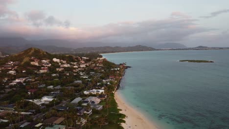 4k cinematic zoom-out drone shot of lanikai beach and the oahu coast on the eastside during sunrise