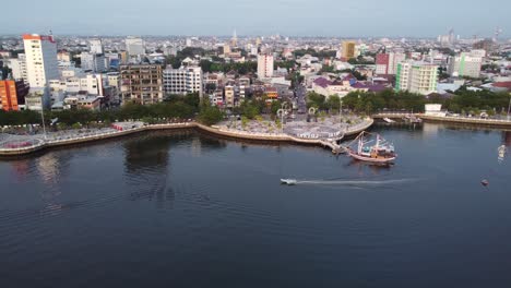 panoramic aerial view of pontianak city waterfront with saroj jati monument and boats