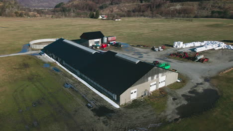 dairy barn, silo, and enclosure for milk production on agricultural landscape in norway