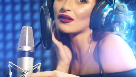 beautiful young singer who recorded a song in a professional recording studio. slow motion