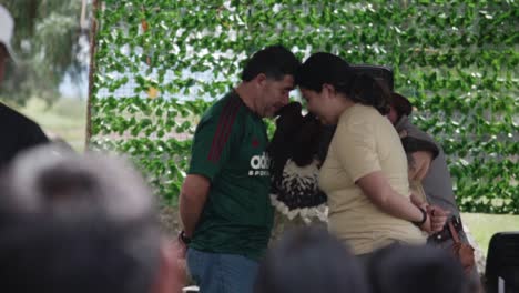 man and woman touching foreheads in a crowd