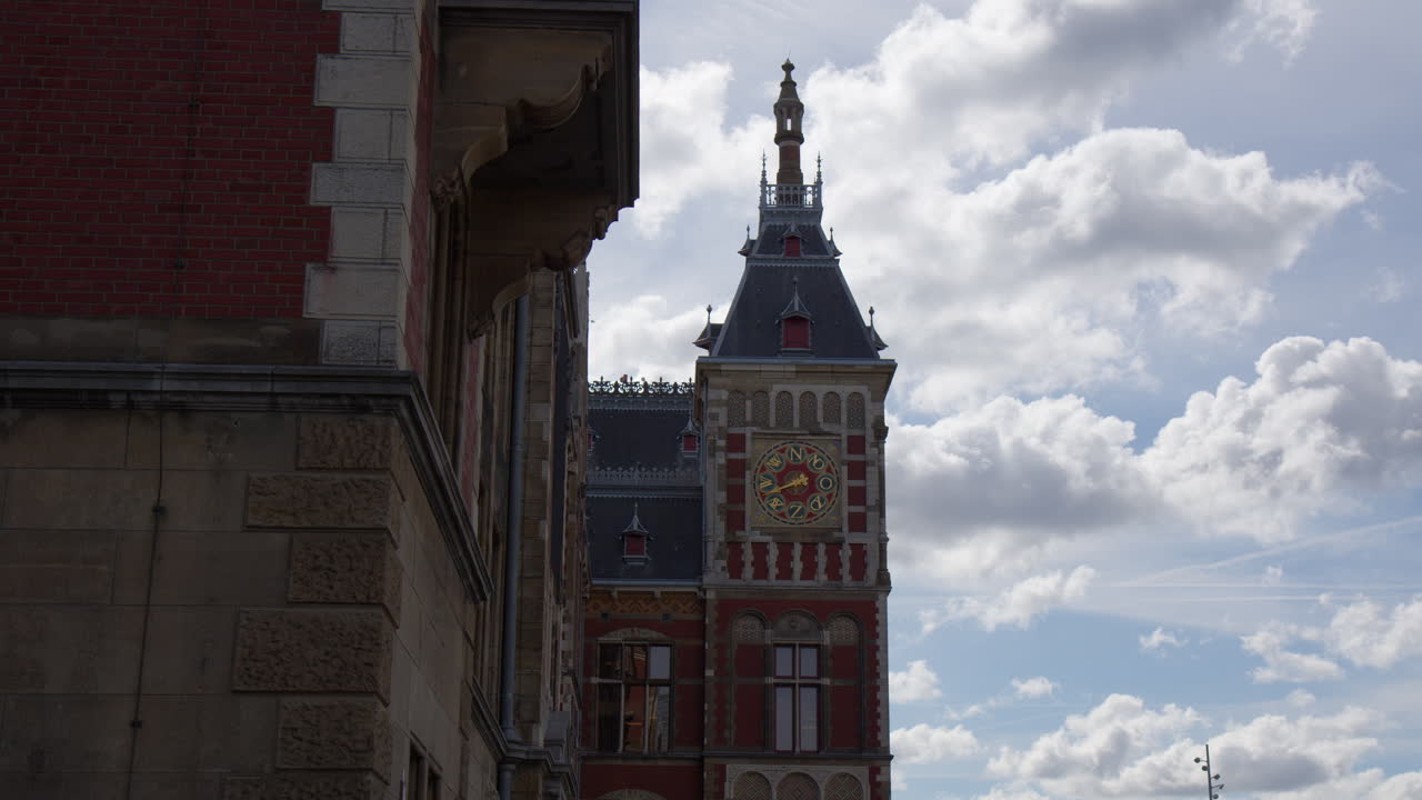 Amsterdam Centraal Railway Station Building Against The Cloudy Sky In Netherlands. Wide shot