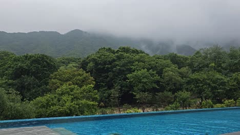 Ourdoor-Infinity-Swimming-Pool-With-Picturesque-Mountain-View-Landscape-in-Early-Morning---eye-angle