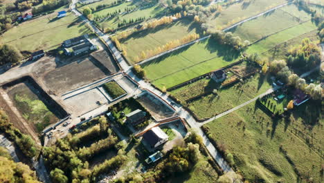 drone flying over a road in the the forest