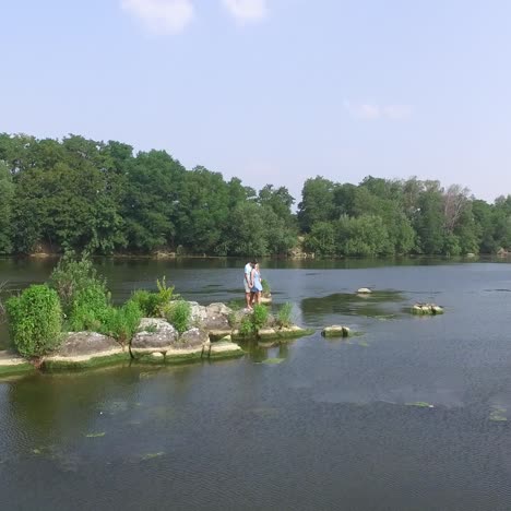 couple resting on river bank