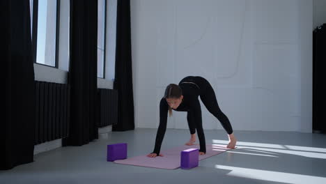 woman practicing yoga in a studio