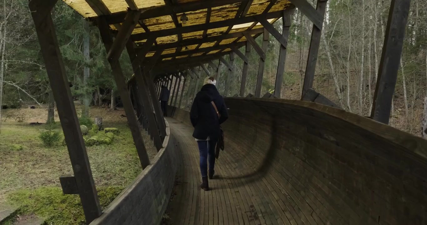 Closeup Of People Walking A Old Bobsleigh Track.