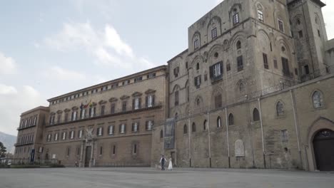 wedding couple in front of a historic palace