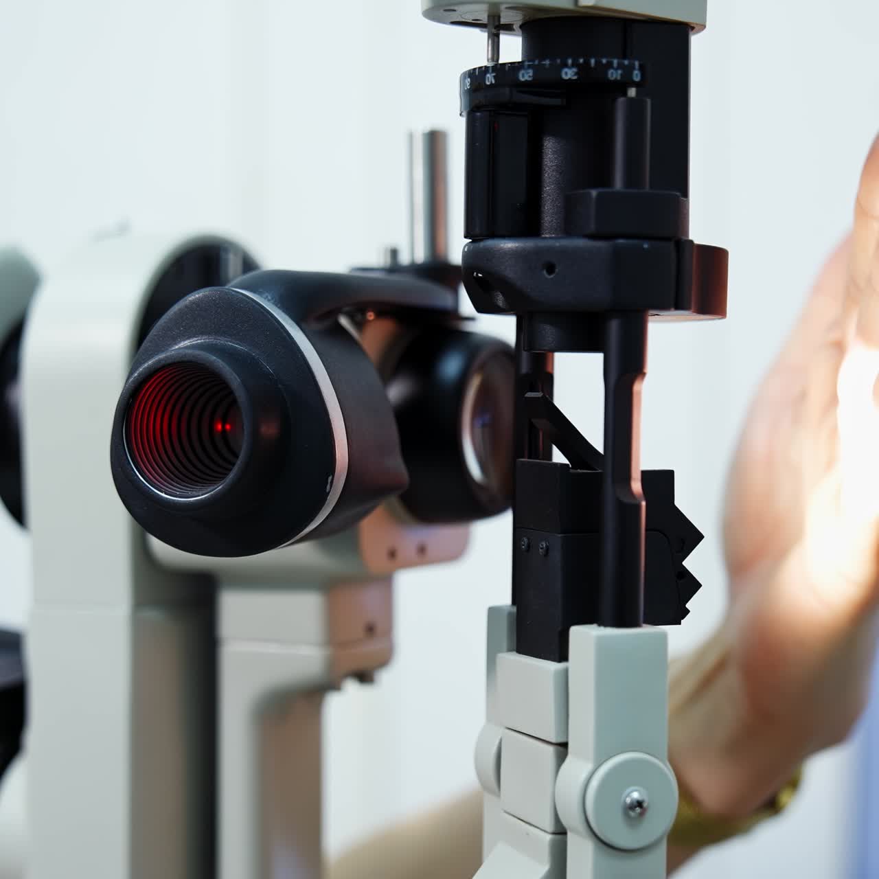Modern medical device in ophthalmology office. Refractometer machine for eyesight examination. Doctor is checking the optical apparatus
