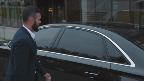 beautiful businesswoman getting out of car