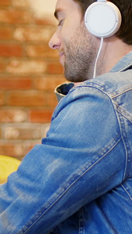 man listening to music on digital tablet