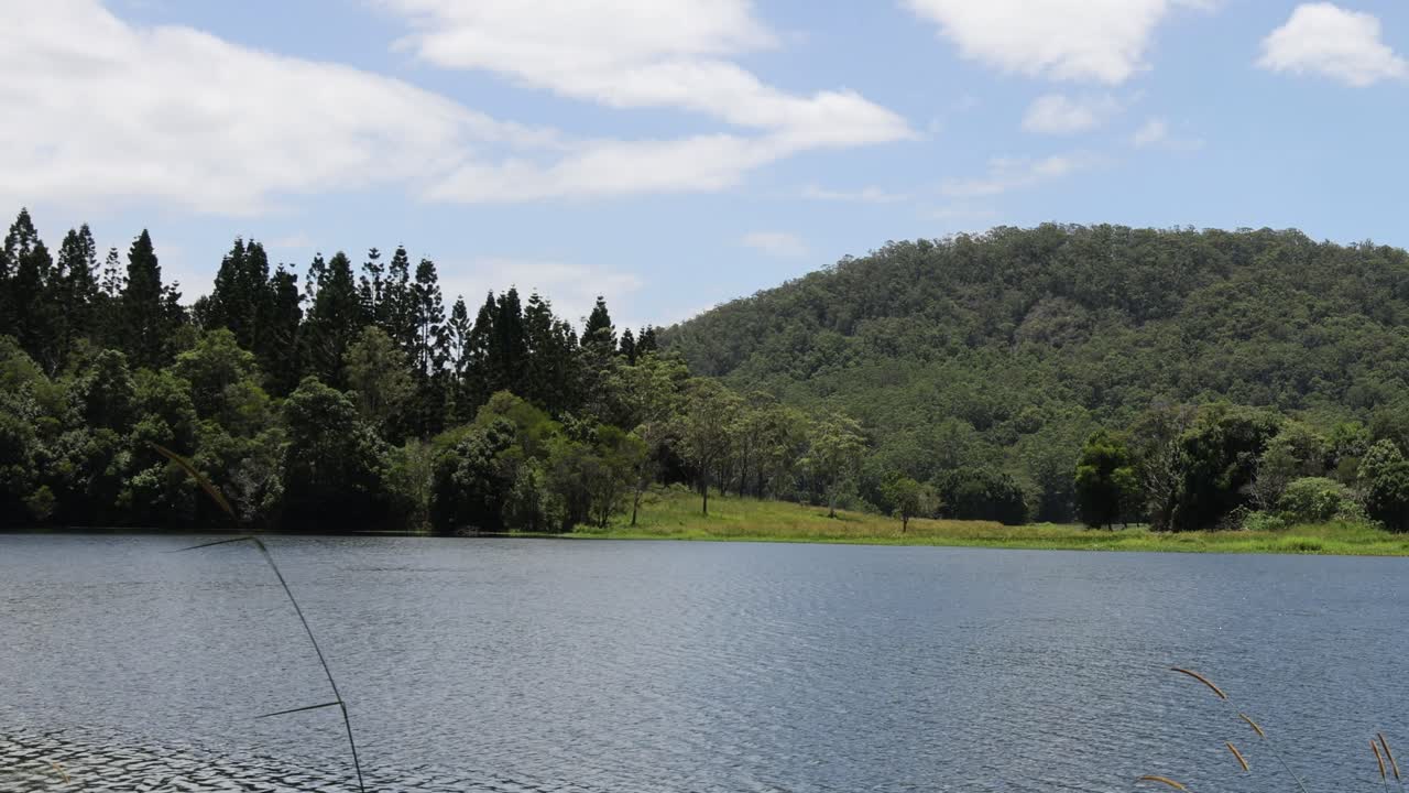 Tranquil view of a lake against forested hills