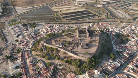 Aerial-birds-eye-view-of-Castelo-de-Castro-Marim-Castle,-village-settlements-and-salt-pans