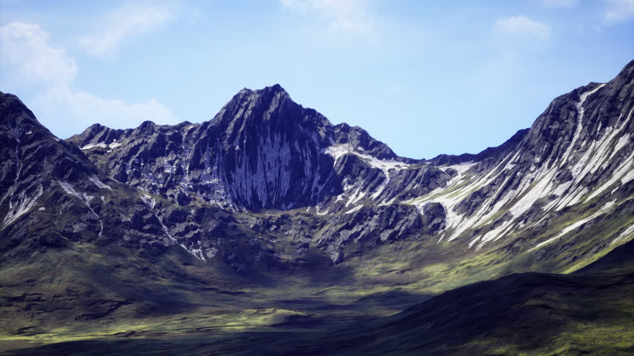 Majestic mountain range surrounded by lush green valleys in daytime