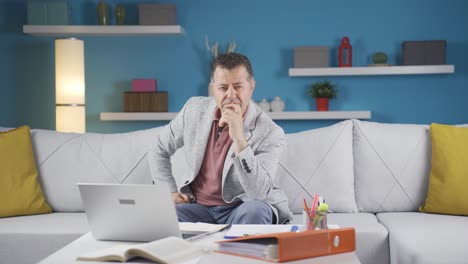 home office worker man thinking looking at camera.
