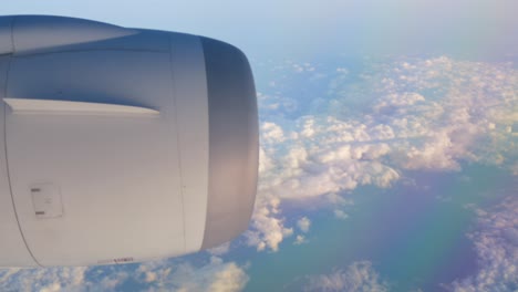 View-of-the-plane's-engine-while-flying-over-the-cloud-level-on-35,000-feet-height-with-full-thrust-engine