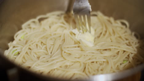 butter melting in a pan of pastas