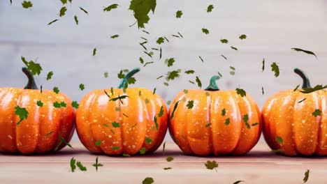Digital-Composite-video-of-autumn-leaves-moving-against-pumpkin-in-background