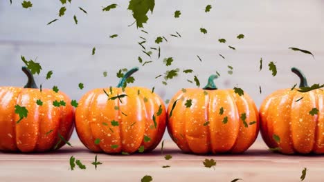 video compuesto digital de hojas de otoño que se mueven contra la calabaza en el fondo