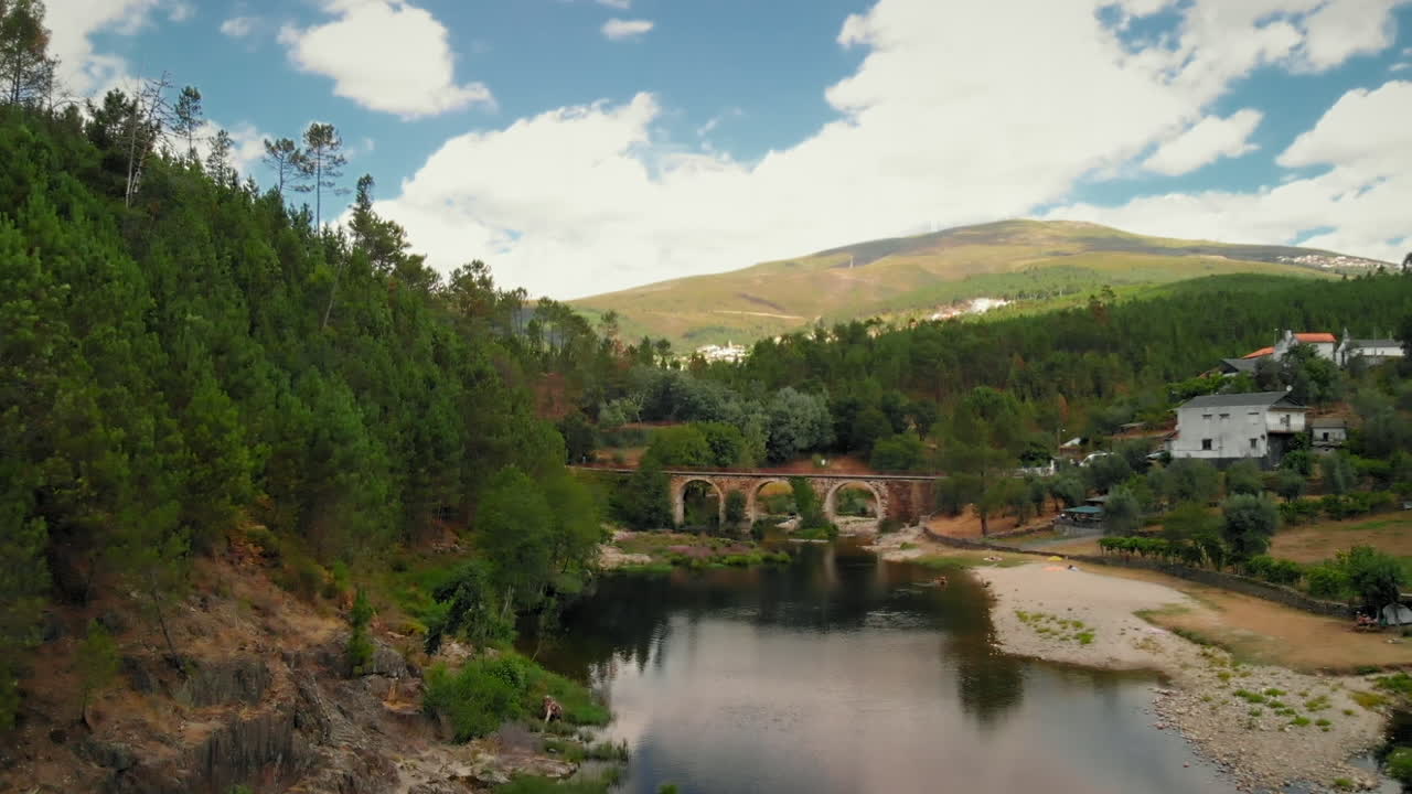 River with a Stone Bridge in a Summer Dav