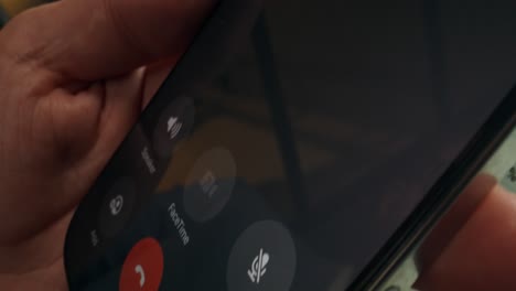 mobile phone call and financial data on laptop