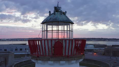 drone dolley shot of picturesque abandoned lighthouse in ireland during sunset