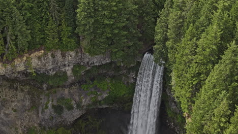 brandywine falls bc canada aerial v4 zoomed birds eye view of creek cascade over a rocky cliff into a deep canyon surrounded by lush forest in provincial park - shot with mavic 3 pro cine - july 2023