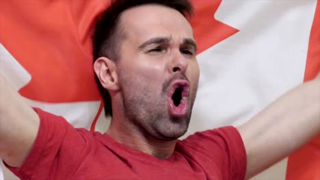 canadian fan celebrating while holding the flag of canada in slow motion ,4k , high quality