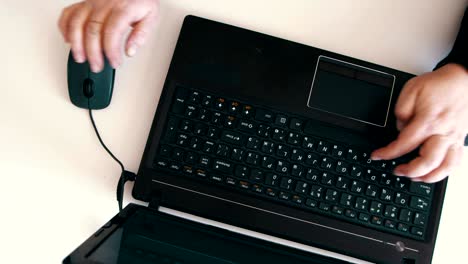 top view of laptop and female hands