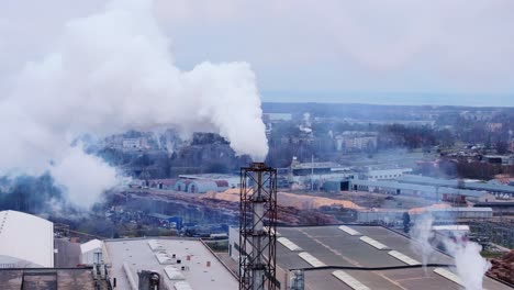 heavy smoke rising from an industrial factory in soviet-era district, gray skies