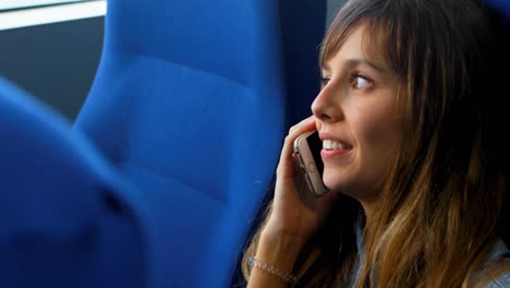 Woman-talking-on-mobile-phone-while-travelling-in-ferry-4k