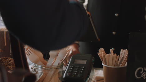 happy-barista-woman-serving-customer-paying-using-smart-watch-contactless-payment-spending-money-buying-coffee-in-cafe