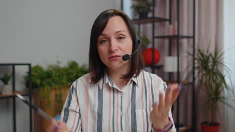 young woman freelancer wearing headset, call center or support service operator helpline having talk