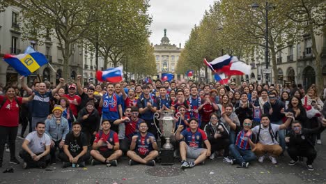 celebrating victory: a thriving crowd of enthusiastic fans gather to commend their team's triumph with flags and a glorious trophy in a spectacular urban setting