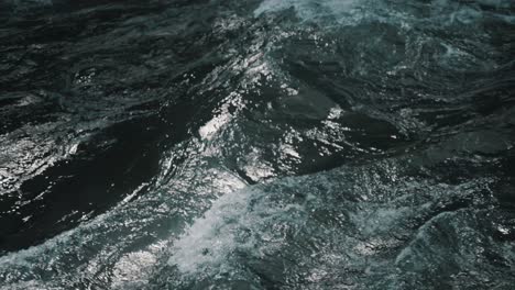 Slow-motion-shot-of-water-flowing-in-a-river-in-Baños-de-agua-santa,-Ecuador