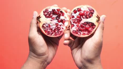 Top-view-of-holding-a-pomegranate-,