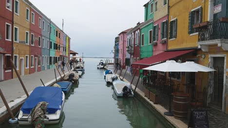 Beautiful colorful houses of Burano, Italy with canal leading to lagoon