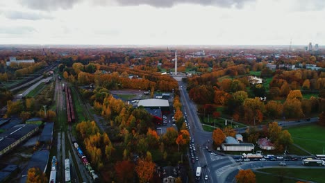 panoramic aerial shows trains, roads, parks beneath vivid fall trees, 10.10.2020