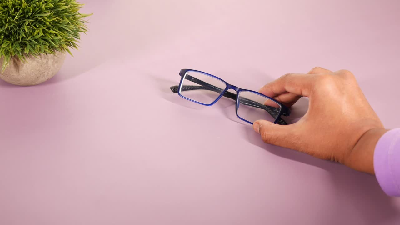 Close up of man hand holding old eyeglass