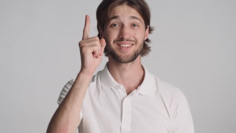 caucasian man in front of camera on gray background.