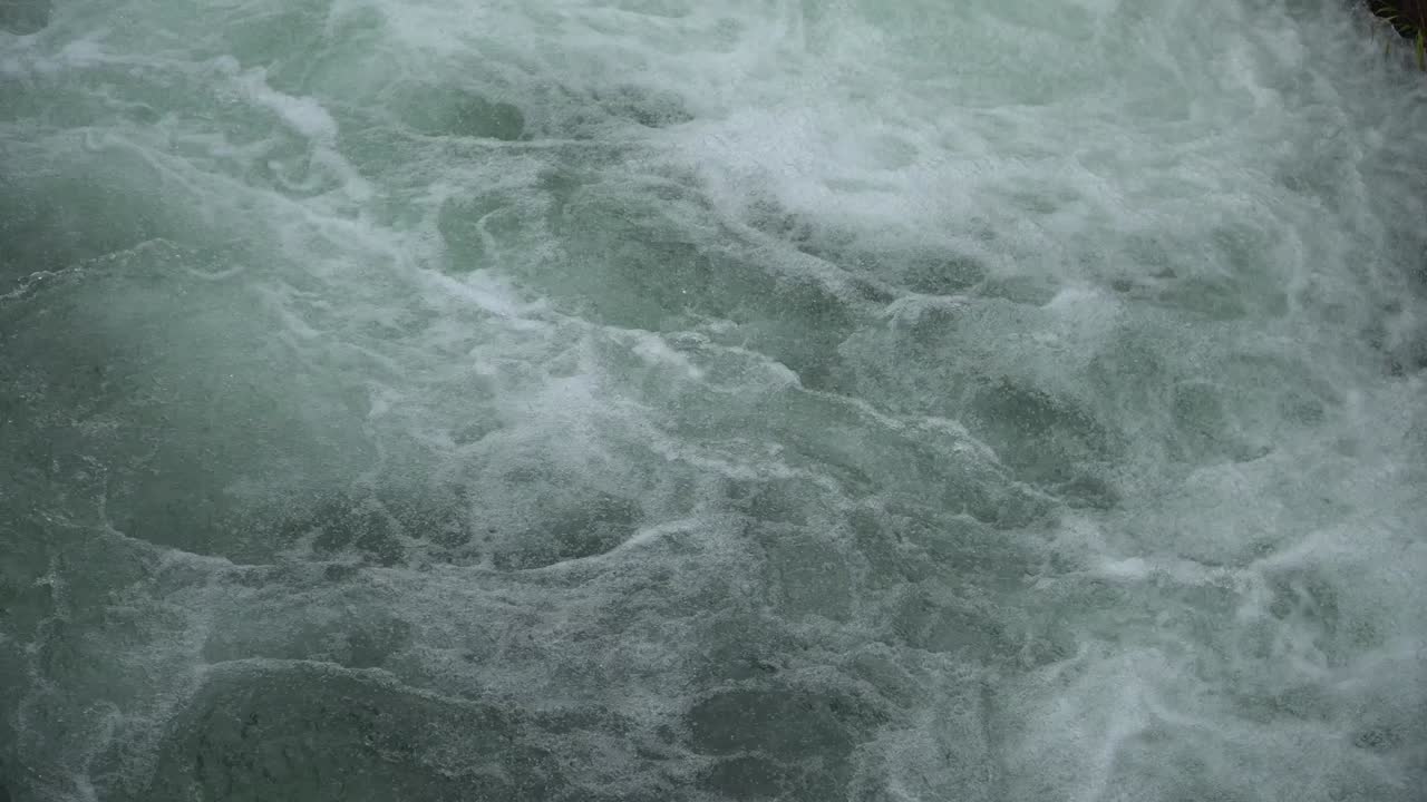 Water swirl in canal Flowing and splashing water in cold river.