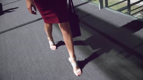 woman walking in the corridor at office 4k