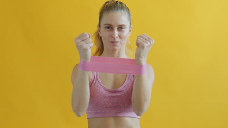 woman performing arm workout with resistance band